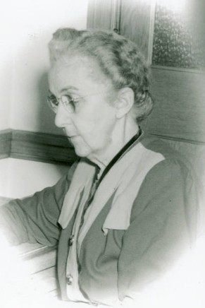 Adeline Halleck with braided hair and glasses.